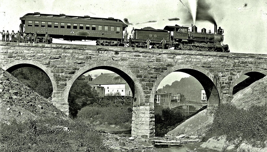 "Connellsville Central Railroad Bridge No. 0.15 over Dunlap Creek Brownsville PA showing Pittsburgh and Lake Erie Railroad No. 86 & Pennsylvania Railroad Maintenance of Way Car No. 191127 1905" by over 26 MILLION views Thanks is marked with CC BY-NC-SA 2.0.
